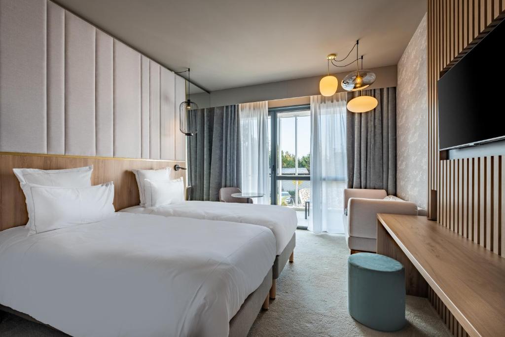 Postel nebo postele na pokoji v ubytování GOLDEN TULIP LYON OUEST TECHLID Hotel & Spa