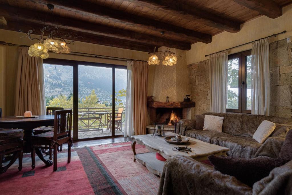 a living room with a couch and a table at Parnassus Dreamwood Chalet in Eptalofos