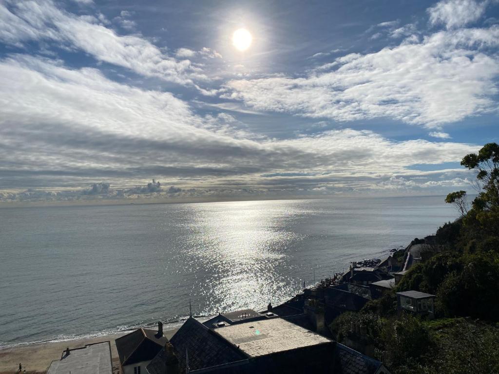 a view of the ocean with the sun in the sky at The Wellington in Ventnor
