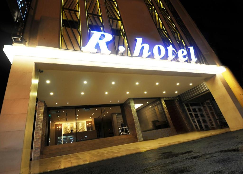 a building with a neon sign on the front of it at The Riverside Hotel Hengchun in Hengchun