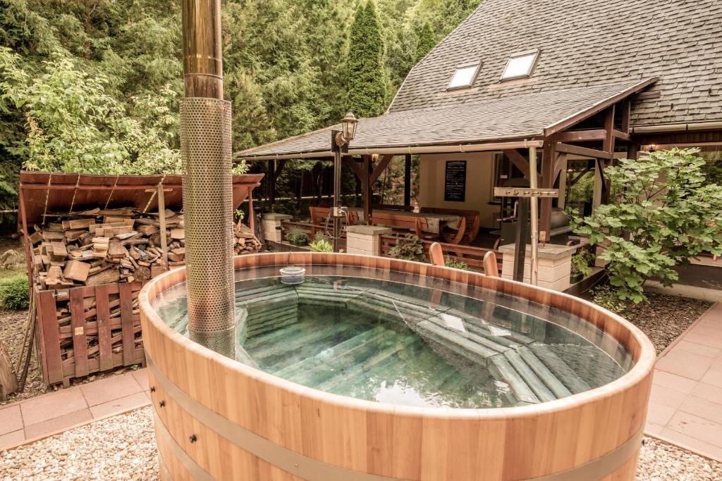 a hot tub in the backyard of a house at Csodaszarvas Vendégház in Sály