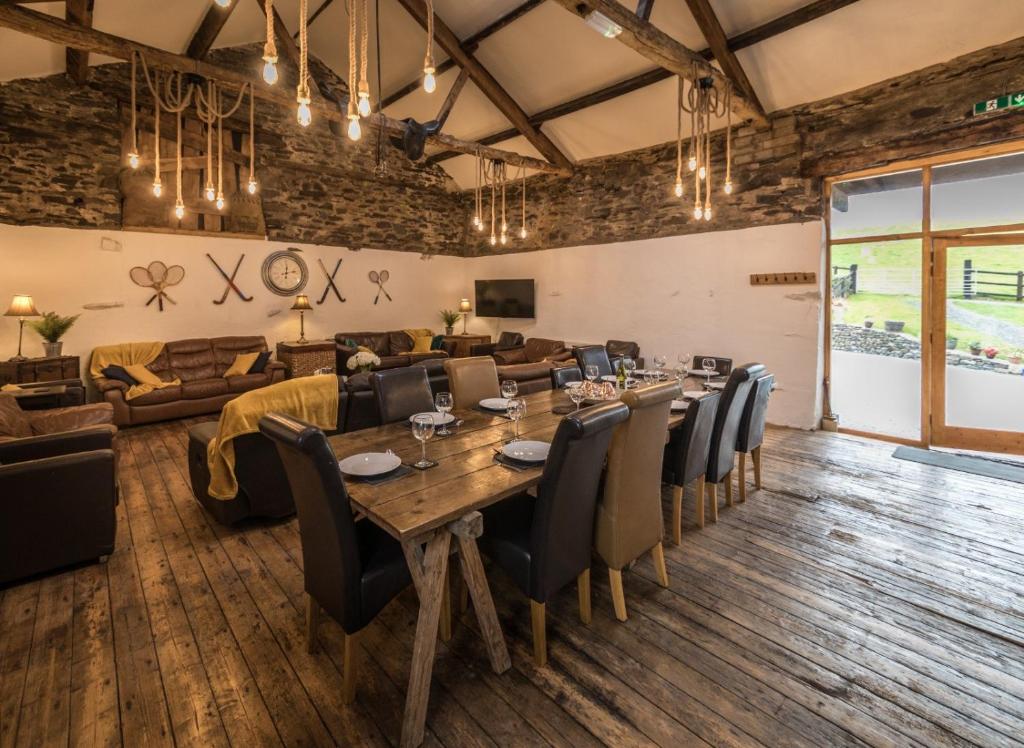 a dining room with a long table and chairs at The Lake District Bunkbarn, Ings in Kendal