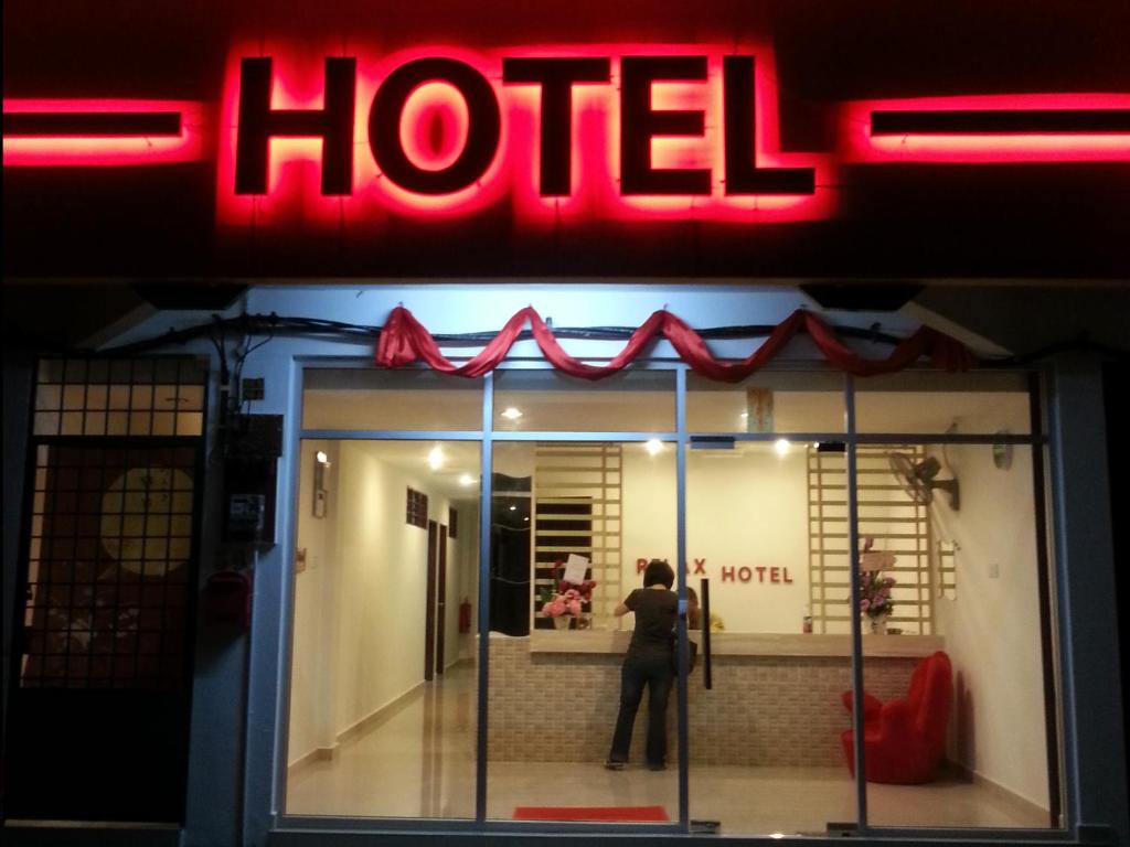 a person standing in the window of a hotel at RELAX HOTEL in Sungai Petani