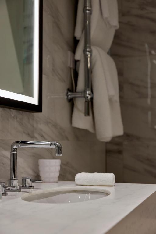 a bathroom sink with a white towel on it at The Parkgate Hotel in Cardiff
