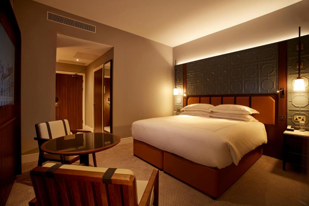 a hotel room with a bed and a table at The Parkgate Hotel in Cardiff