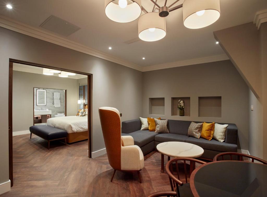 a living room with a couch and a bed at The Parkgate Hotel in Cardiff