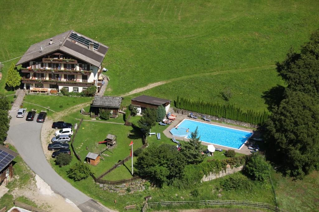 an aerial view of a house and a swimming pool at Pension Gasthof Haselstaude in San Leonardo in Passiria
