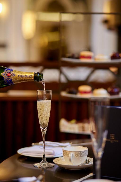 a bottle of champagne is being poured into a glass at The Parkgate Hotel in Cardiff