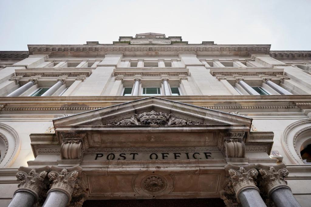 a tall building with the post office sign on it at The Parkgate Hotel in Cardiff