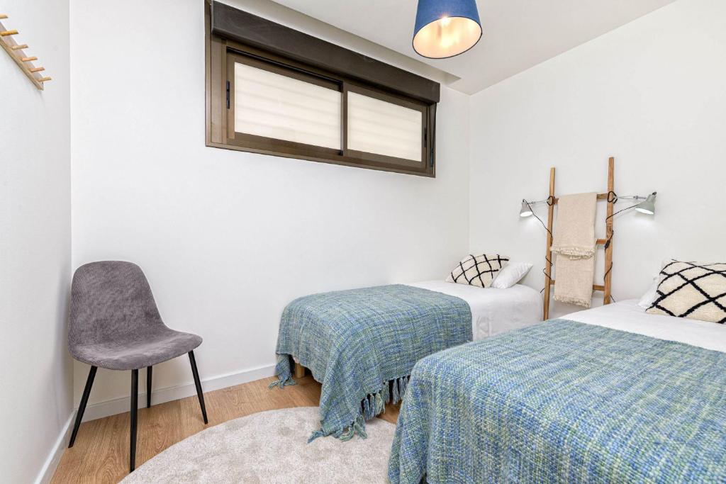 Łóżko lub łóżka w pokoju w obiekcie Teatro Apartment in Malaga by Solaga Holiday Homes