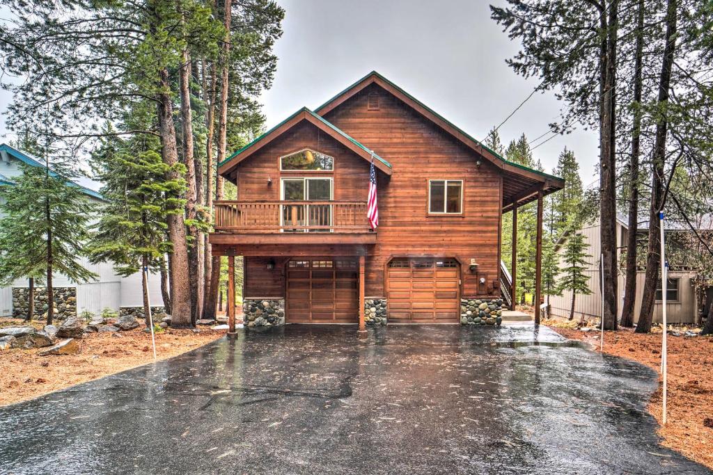 a log home with a garage in the woods at Luxe Truckee Cabin with Golf Course View and Deck in Truckee