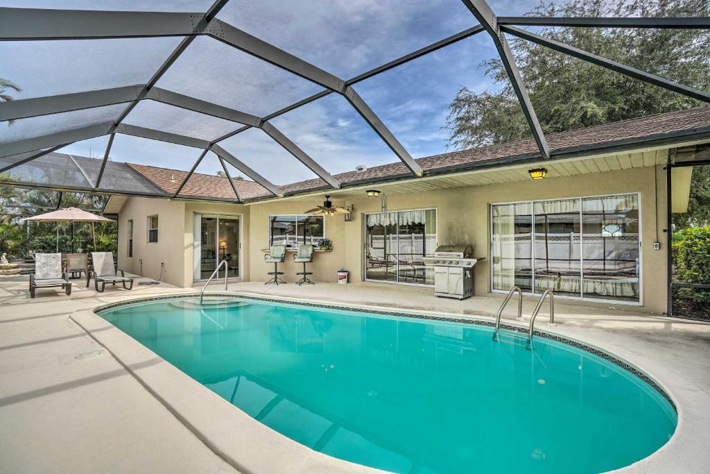 an indoor swimming pool with a glass roof at Marco Island Retreat with Pool about 1 Mi to Beach in Marco Island