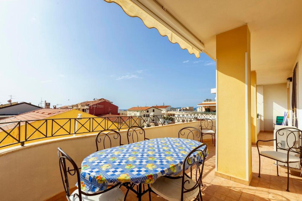 a balcony with a table and chairs on a balcony at Adriatico apartment in Alghero