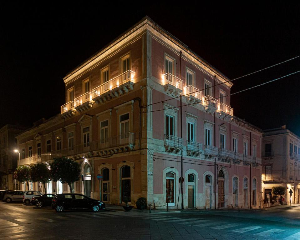 a building with lights on top of it at night at Apollo Suite in Siracusa