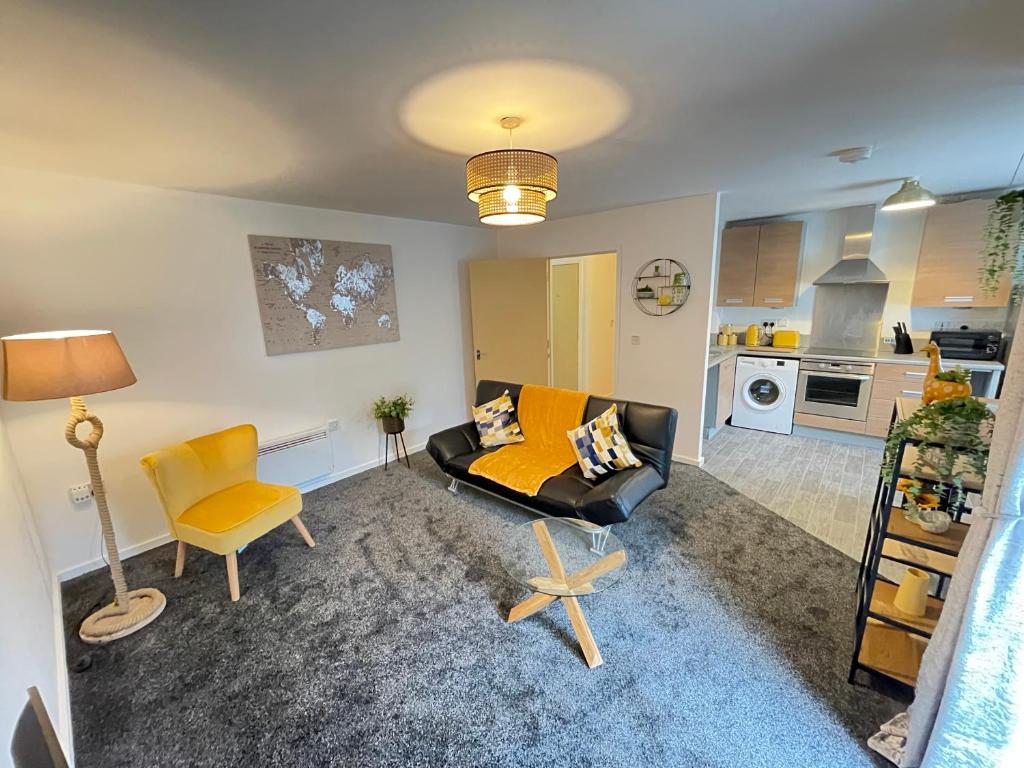 a living room with a couch and a chair at Grand Central Littleover Deluxe Apartments in Derby