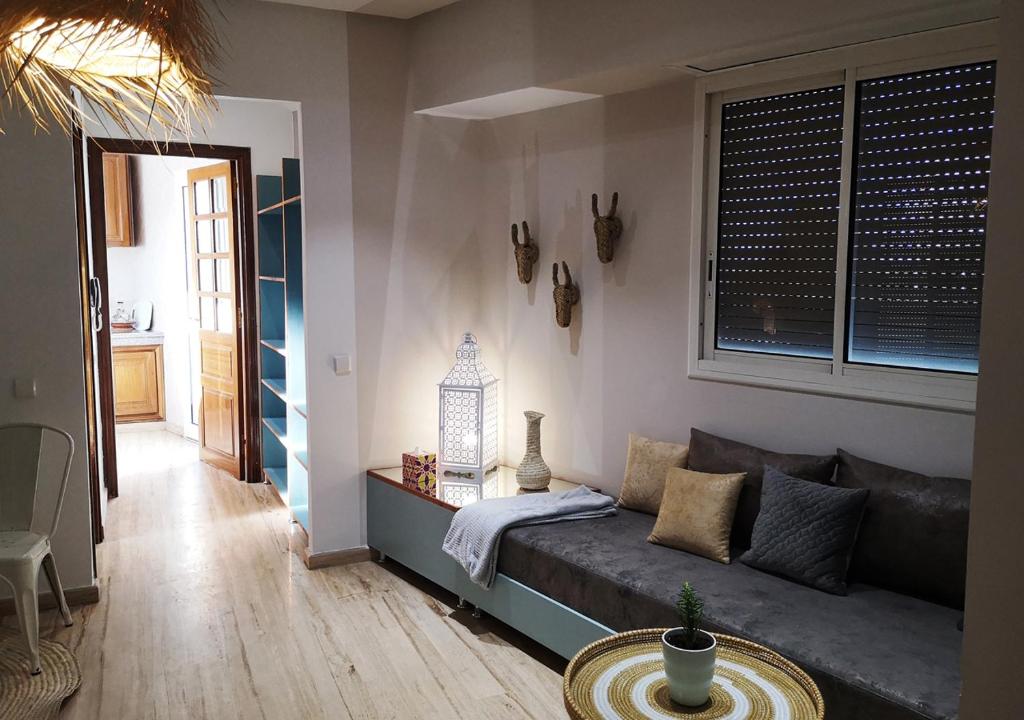a living room with a couch and a table at LAU 09 Studio Terrasse in Rabat