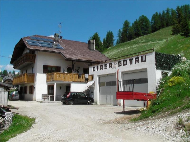 a building with a car parked in front of it at Appartamenti Suttru in Badia