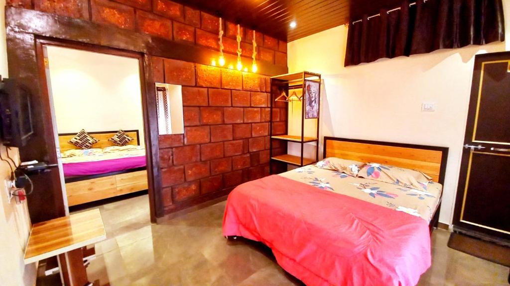 a small bedroom with a bed and a mirror at Dadaji Cottage, a unit of DADAJI VILLA in Panchgani