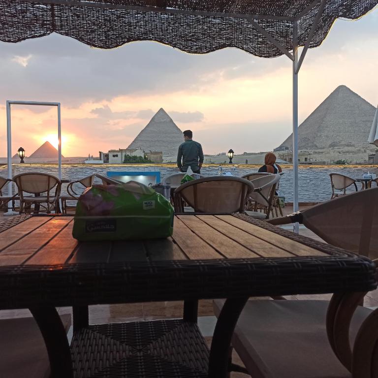 a picnic table in front of the pyramids at Pyramids Top Inn in Cairo