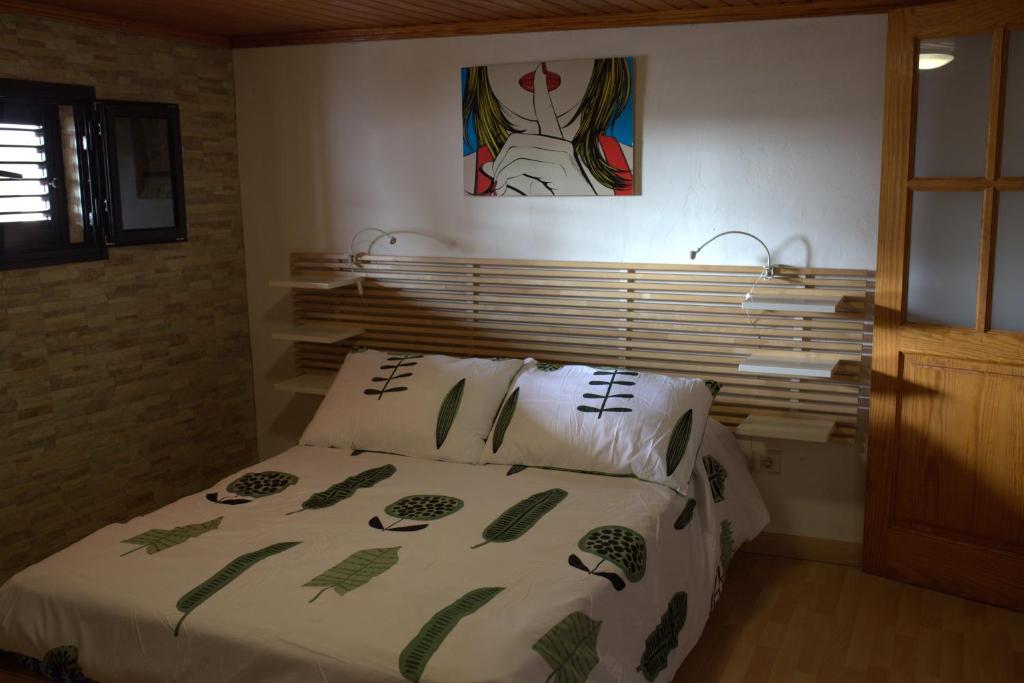 a bedroom with a bed and a painting on the wall at CASA ALIS in Arrecife