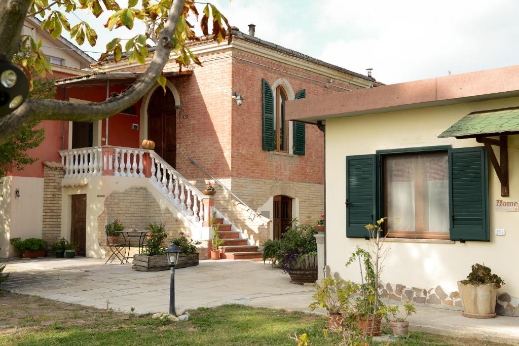 a brick house with a staircase in front of it at La Casa Di Andrea in Chieti