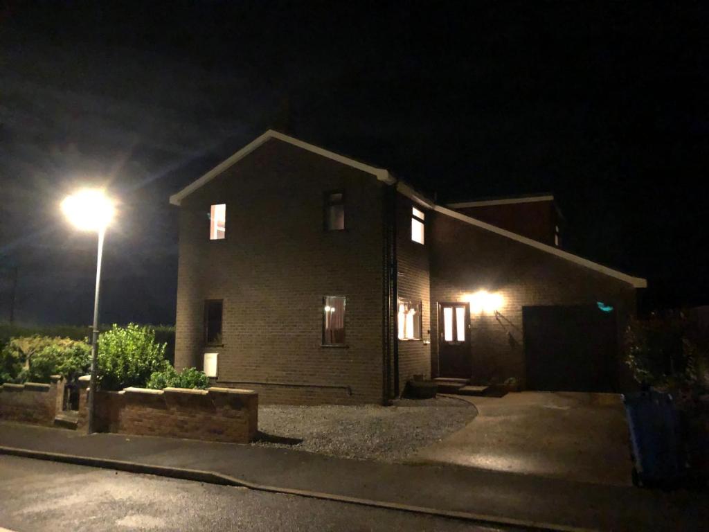 a house at night with a street light at Number One - Fully Equipped Self Catering Four Bedroom House next to Dunedin, 15 mins to Spurn, 20 mins to Saltend, 12 mins to Easington in Patrington