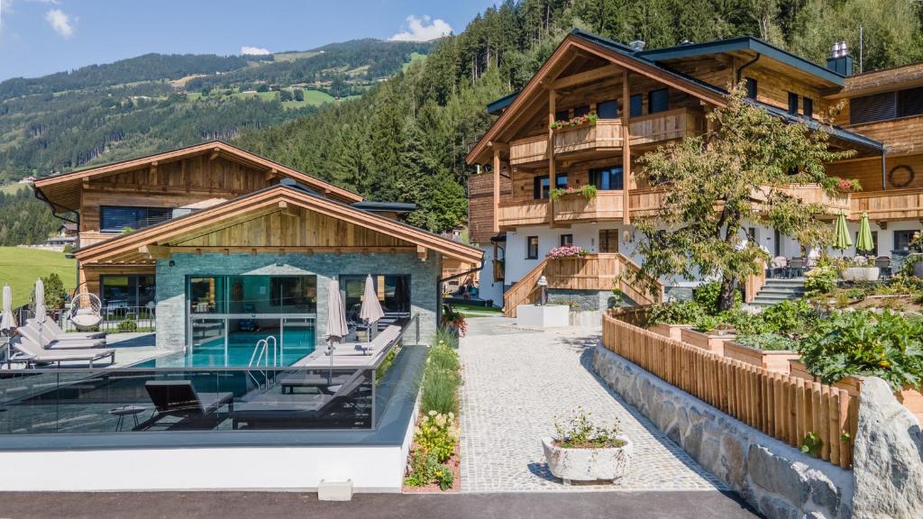 a house in the mountains with a swimming pool at Hochfeldhof in Zell am Ziller