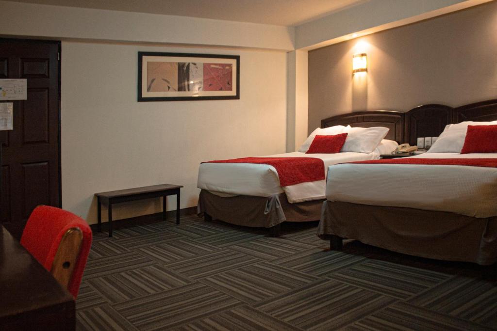Postel nebo postele na pokoji v ubytování Ramada Plaza by Wyndham Leon