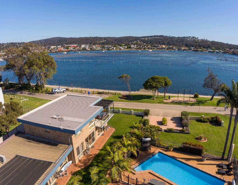 an aerial view of a house with a swimming pool at Lakeside Holiday Apartments Merimbula in Merimbula