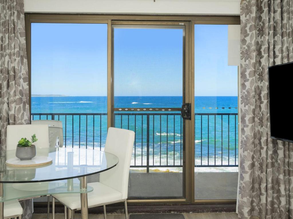 a dining room with a view of the ocean at Waterfront Unit 2 in The Entrance
