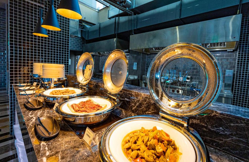a buffet with plates of food on a counter at Kenting Long Beach Hotel in Checheng