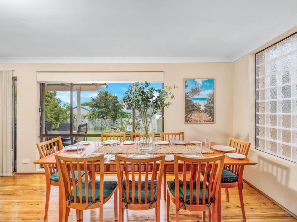 a dining room with a table and chairs at The Golden Ticket by Experience Jervis Bay in Vincentia