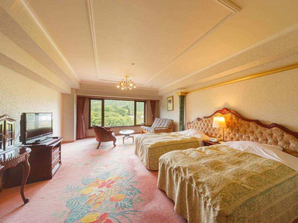 Postel nebo postele na pokoji v ubytování Jozankei View Hotel