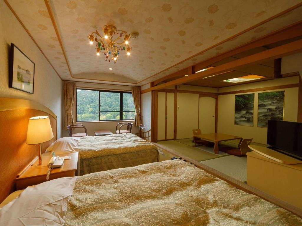 Postel nebo postele na pokoji v ubytování Jozankei View Hotel