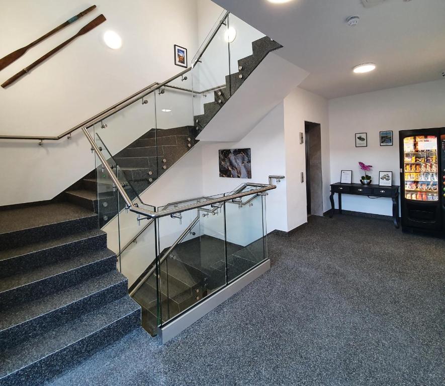 a staircase with glass railing in a building at Milltate House Apartments in Irvinestown