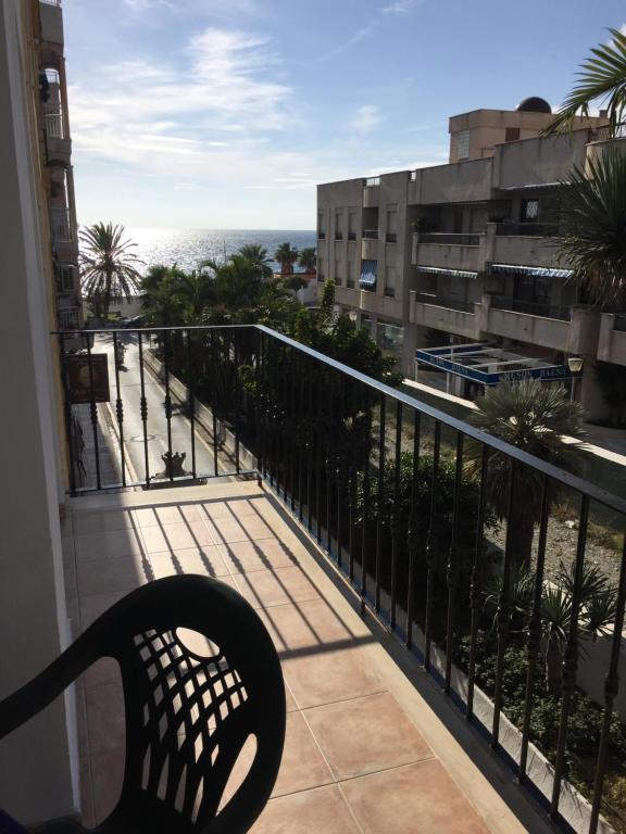 a balcony with a bench looking out at the ocean at El SOL del SUR in La Herradura