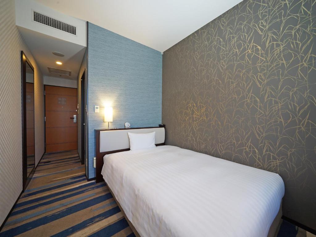 Postel nebo postele na pokoji v ubytování LOISIR HOTEL SHINAGAWA SEASIDE
