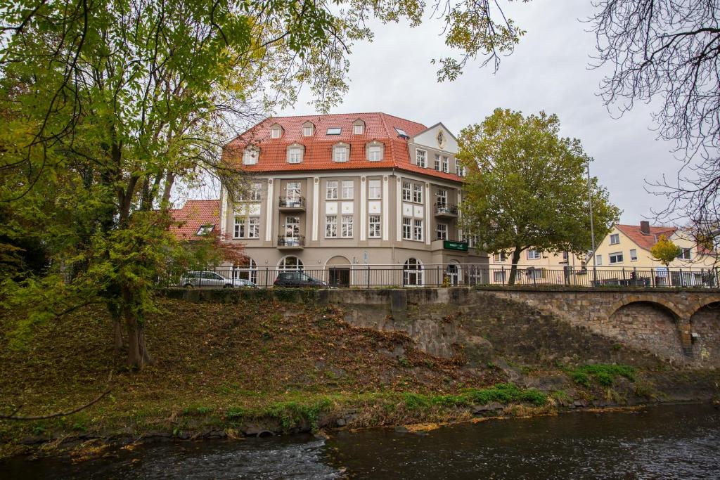 a large building on a bridge over a river at aappartel APARTHOTEL Herford in Herford