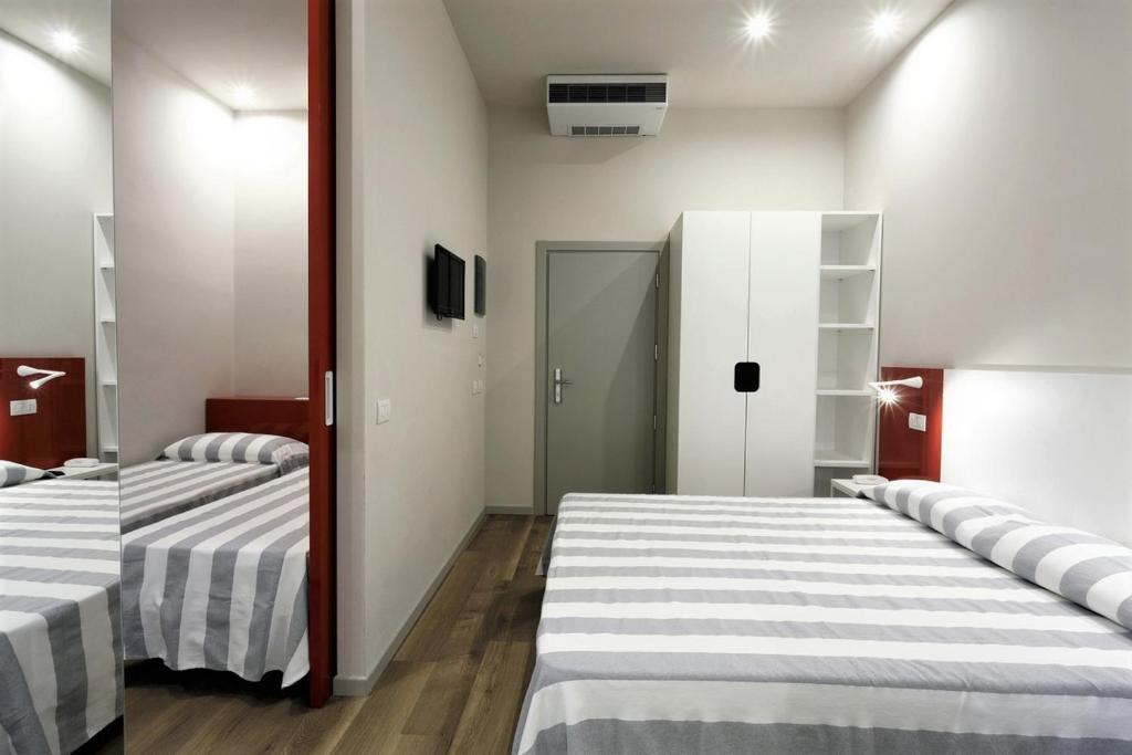 Postel nebo postele na pokoji v ubytování Hotel Aurea