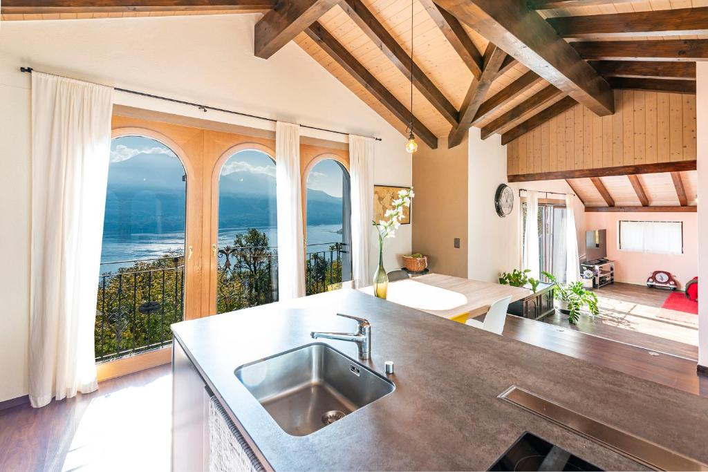 a kitchen with a sink and a view of the ocean at CASA LUNA - WONDERFUL LAKE VIEW in Brione sopra Minusio