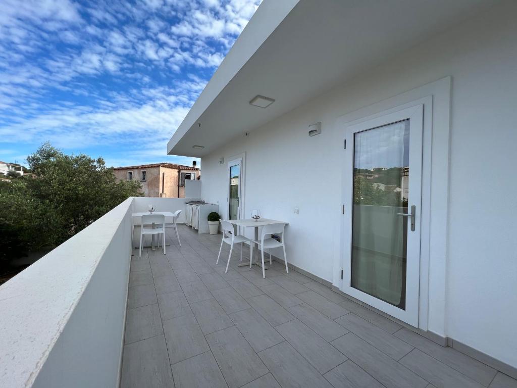 a white balcony with a table and chairs on it at Al Mare da Francesca in Olbia