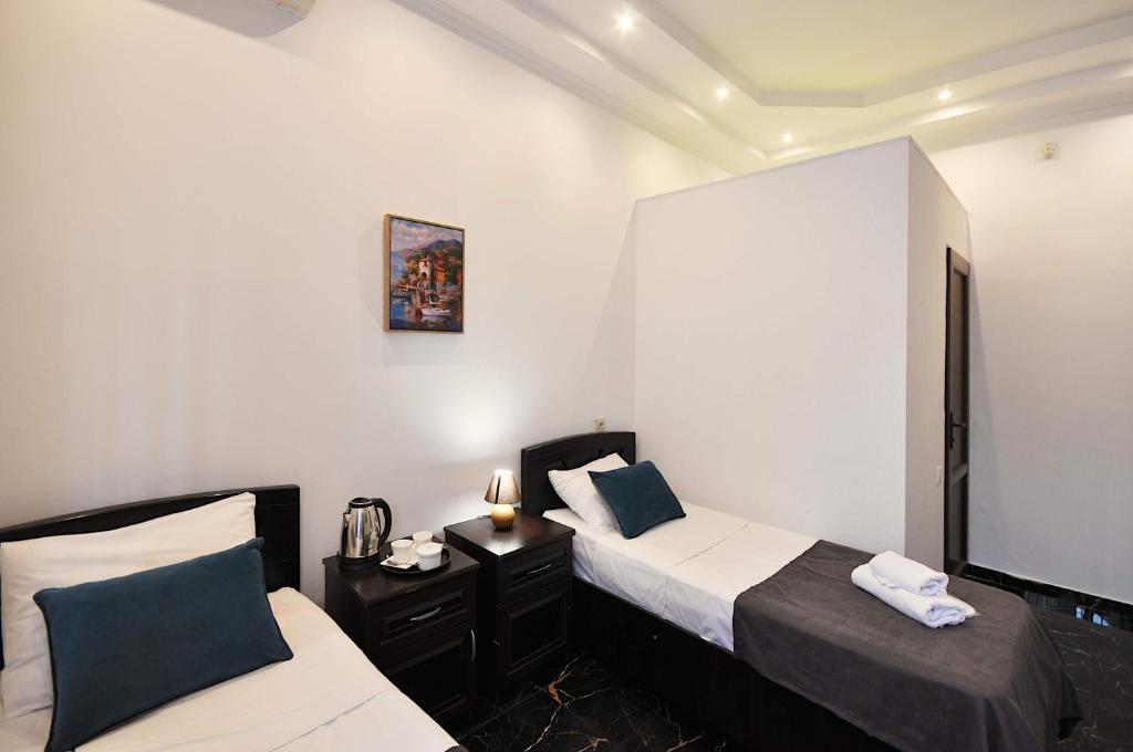 Postel nebo postele na pokoji v ubytování Hotel Majestic