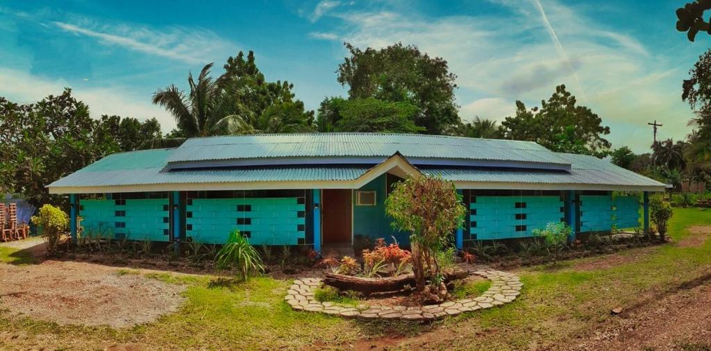 a blue house with a blue roof at House of TamSe Laagans ' Inn in Badian