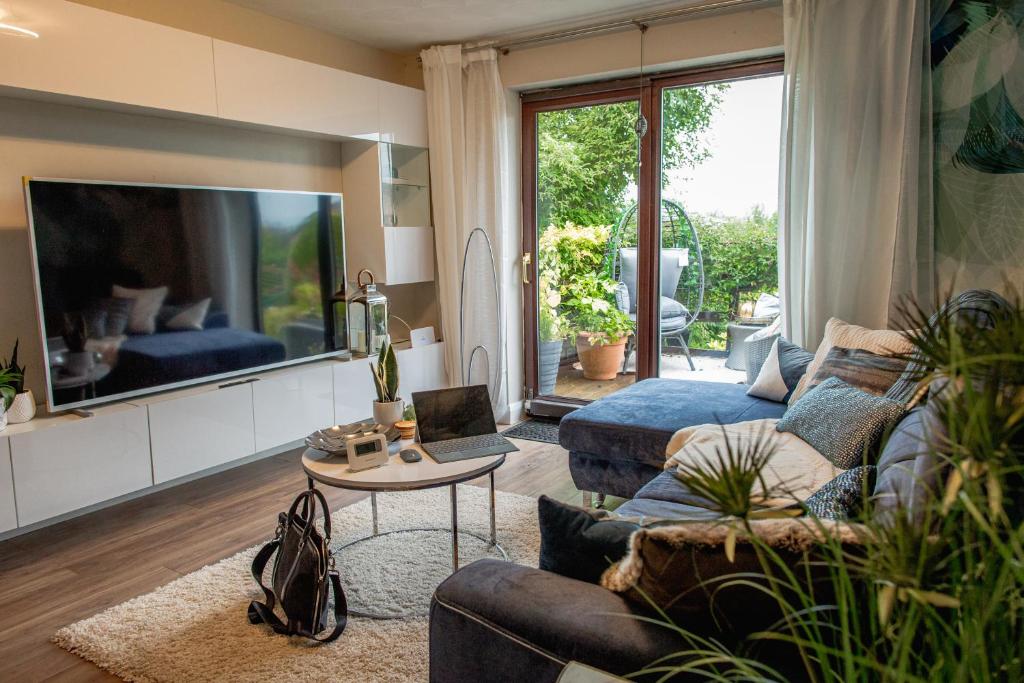 a living room with a couch and a tv at Kelswick Lodge in Nelson