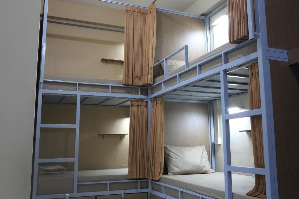 a couple of bunk beds in a room at Aru House Ubud in Ubud