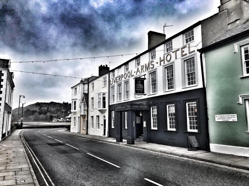 a black and white photo of a street with buildings at The Liverpool Arms Hotel in Beaumaris