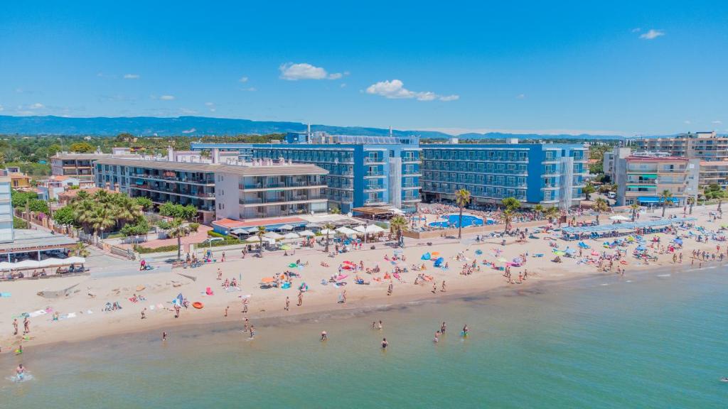 a group of people on a beach near the water at Apartamentos Turísticos Augustus in Cambrils