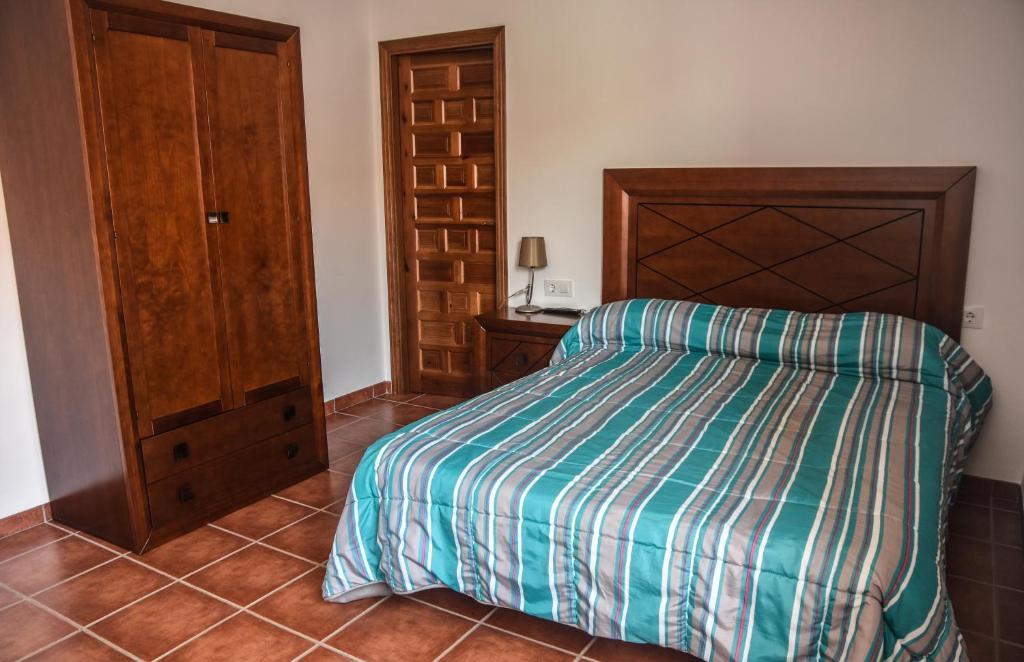 Ένα ή περισσότερα κρεβάτια σε δωμάτιο στο Suites Trastámara