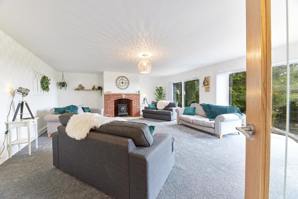 a living room with two couches and a fireplace at Host & Stay - Highfield in Newton on the Moor