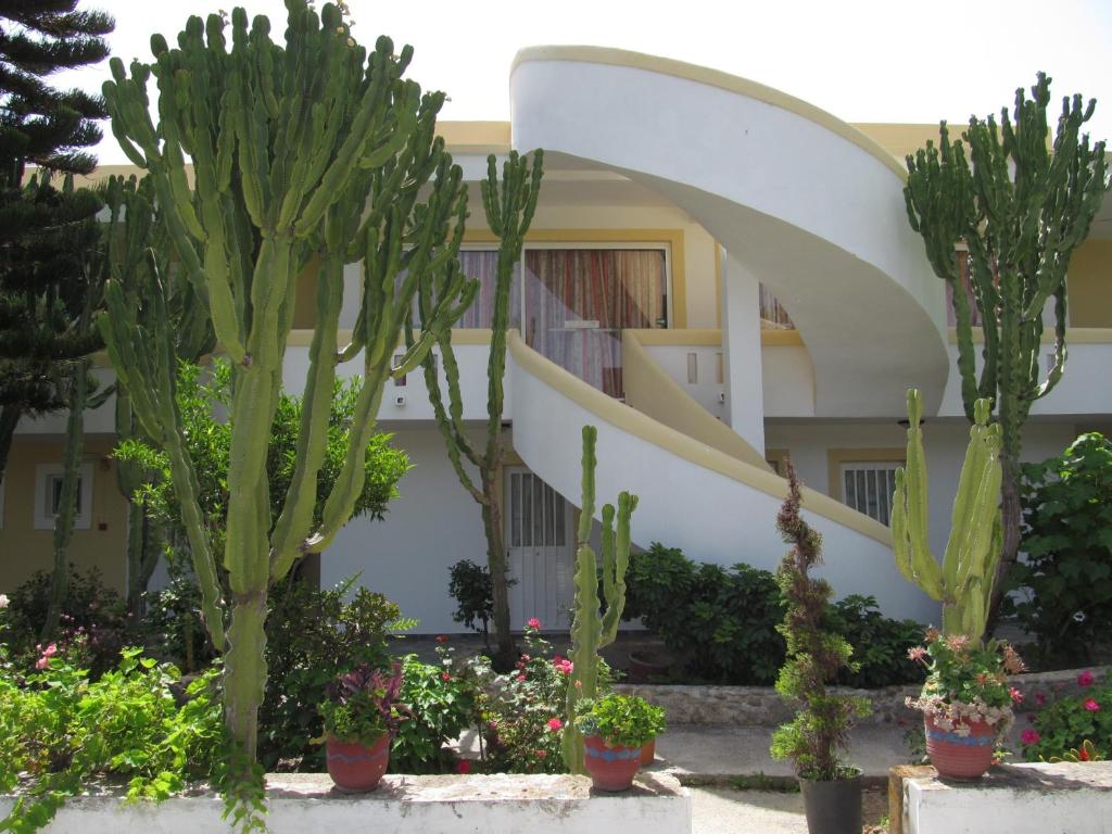 a building with cacti and plants in front of it at Afentoulis Studios 2 in Kefalos